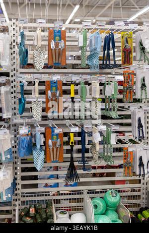 Moscow, Russia - March 31, 2026: Display of gardening accessories in an indoor store Auchan setup. Stock Photo