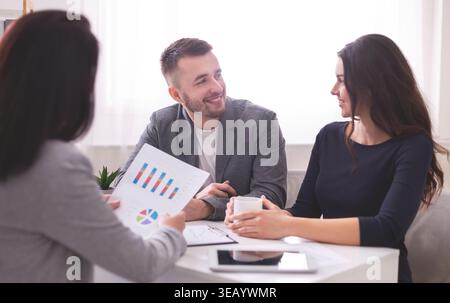 Business Meeting With Colleagues Discussing Sales Figures and Strategy at a Modern Office Stock Photo