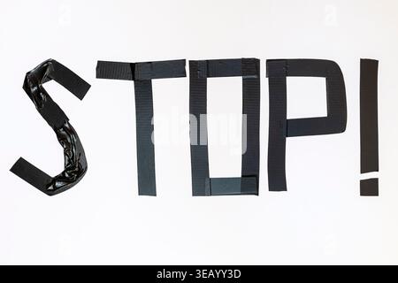 The "STOP!" sign was made with black electrical tape on a white background Stock Photo