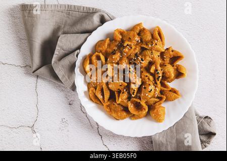 Close up of spicy miso pasta shells on a plate on the table top view Stock Photo