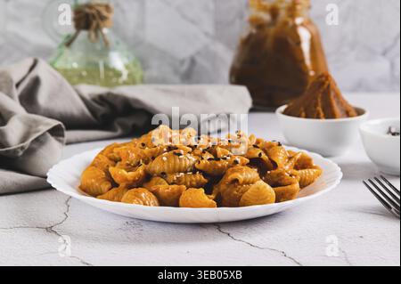 Spicy miso pasta shells on a plate on the table Stock Photo
