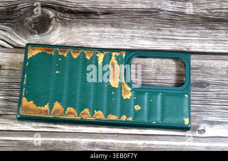 Cairo, Egypt, April 11 2026: A Well-worn green phone case appears to be a generic leather or silicone bumper cover designed for mobile phones like the Stock Photo