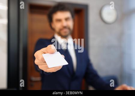 Close Up Male Concierge Handing Blank Key Card to Customer at Reception Desk Stock Photo