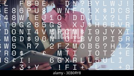 Standing team in business casual viewing laptop tablets at office under code overlay Stock Photo
