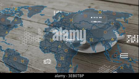 Displaying white ceramic cup with saucer resting on worn wood table, overlaying world map markers Stock Photo