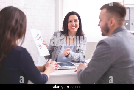 Business Meeting Discussing Financial Reports With Colleagues in a Modern Office Stock Photo