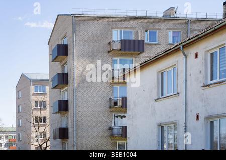Exterior of Eastern European brick apartment buildings featuring Soviet era architecture and typical residential balconies for real estate and urban h Stock Photo