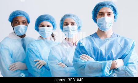 Surgeons Team. Doctors Wearing Protective Uniform, Look At Camera Stock Photo