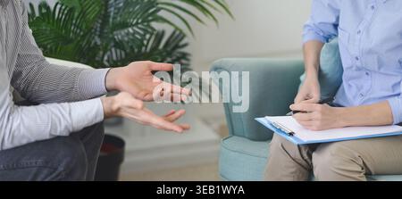 Engaging in a Thoughtful Discussion During a Counseling Session at a Cozy Home Setting Stock Photo