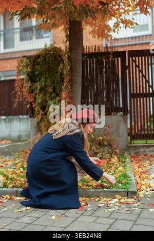 Woman with fall foliage background, calm mood and seasonal colors. Stock Photo