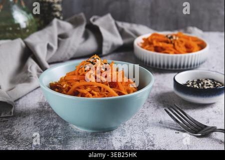 Korean carrots with sesame seeds in a bowl on the table Stock Photo