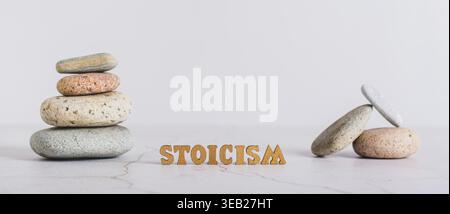 Concept stoicism word made from letters and pyramid of stones on gray background web banner Stock Photo