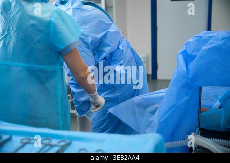 Medical professionals performing procedure in operating room Stock Photo