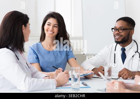 Intern with mentor talking and discussing questions Stock Photo