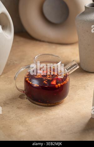 Herbal tea with spices in glass teapot Stock Photo