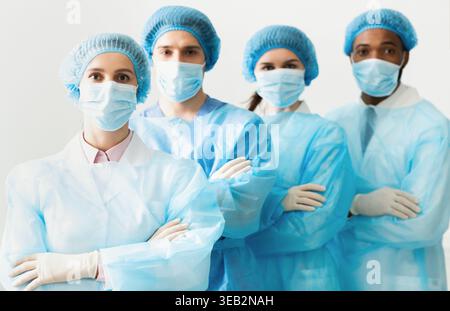 Surgeons Team Wearing Protective Uniforms, Standing In Row Stock Photo