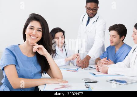 Young Intern Looking At Camera At Conference Stock Photo
