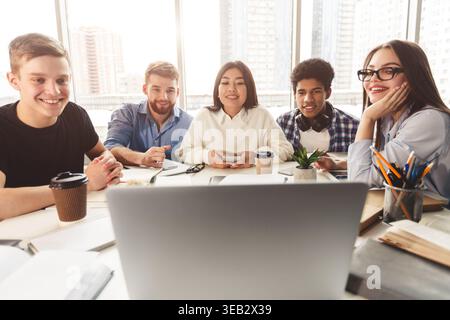 Online lesson. Students learning by laptop in library Stock Photo