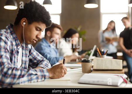 Student guy doing homework and preparing for exam Stock Photo