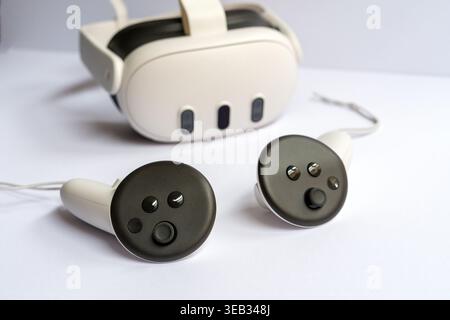 Modern virtual reality headset with wireless controllers on white background, VR technology concept, gaming and immersive experience device Stock Photo