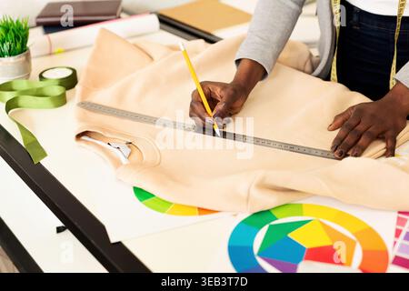 Crafting a Custom Clothing Design Using Tools and Vibrant Color Palettes in a Bright Workspace Stock Photo