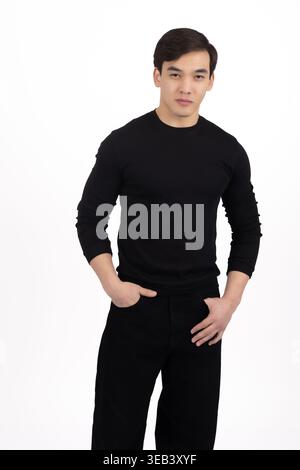 Man in black clothes standing and looking at camera Stock Photo