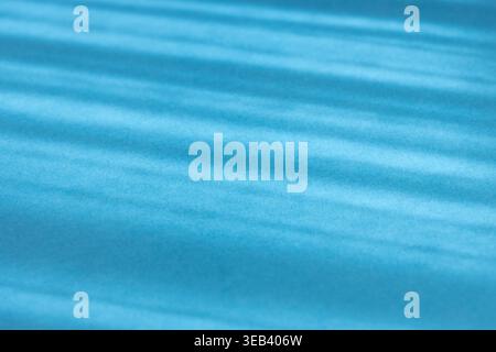 Abstract blue background showing sunbeams casting diagonal shadows and light stripes Stock Photo