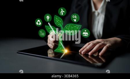 Digital Innovation in Sustainable Development with Green Technology Symbols and Hands Engaging on a Tablet Device for Eco-Friendly Solutions Quark. Stock Photo