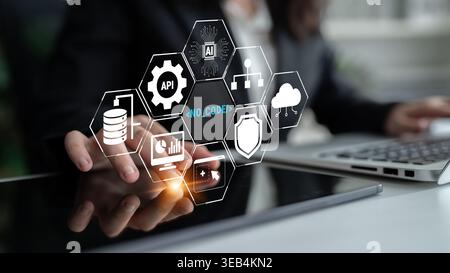 Business Professional Engaging with Digital No-Code Technology Icons in a Modern Office Environment, Showcasing Data Management and Cloud Solutions Stock Photo
