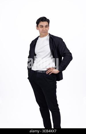 Young man standing and posing with hands in pockets Stock Photo