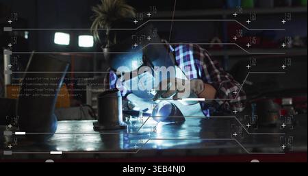 Welding female welder working at metal shop bench with torch, helmet, gloves, plaid shirt, HUD Stock Photo