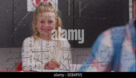 Writing kid wearing white purple-scrunchie holding green pencil on paper at desk glass math overlay Stock Photo