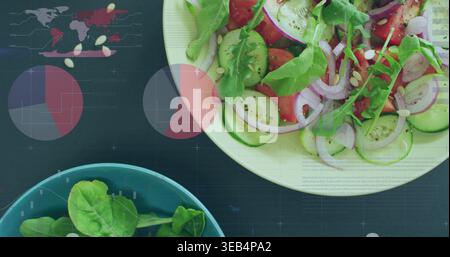 Displaying large white salad bowl sitting on dark tabletop, with teal bowl and infographic overlays Stock Photo