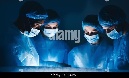 Perform Operation. Surgeon Team Working In Hospital Stock Photo