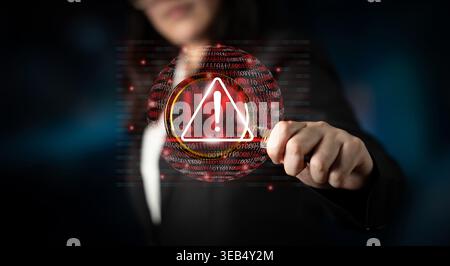 A businesswoman displays a warning symbol against a backdrop of binary code, symbolizing the importance of cybersecurity and data protection in the Stock Photo