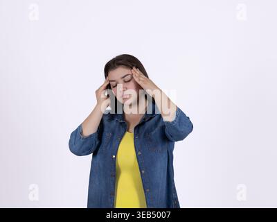 Woman touching her temples feeling a headache or stress Stock Photo
