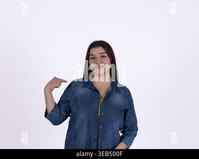 Young woman pointing at herself with a thumb Stock Photo