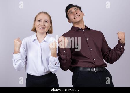 Happy man and woman showing victory sign Stock Photo