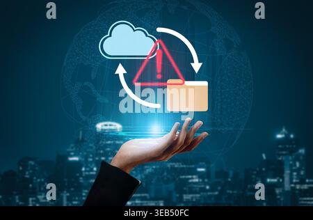 A hand holds a cloud computing symbol with a warning sign and folder, representing modern challenges in data security and management in a digital Stock Photo