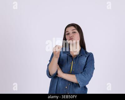 Young woman holding a blank white card or credit card Stock Photo