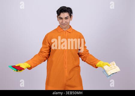 Man in orange uniform holding work equipment Stock Photo