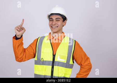 Happy construction worker pointing up with a finger Stock Photo