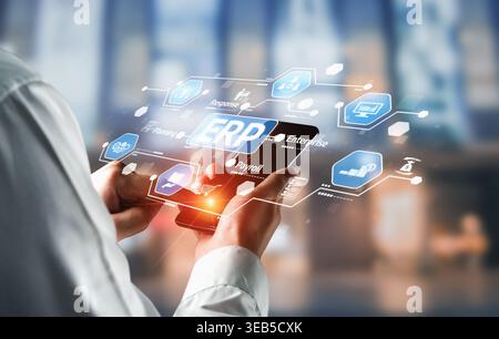 A business professional engages with an ERP software interface on a mobile device, highlighting the integration of technology in modern enterprise Stock Photo