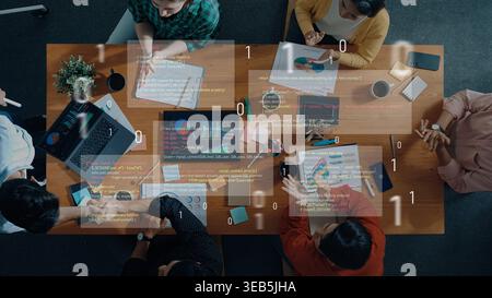 A diverse group of professionals engages in a collaborative brainstorming session, analyzing data and coding on laptops, creating innovative Stock Photo