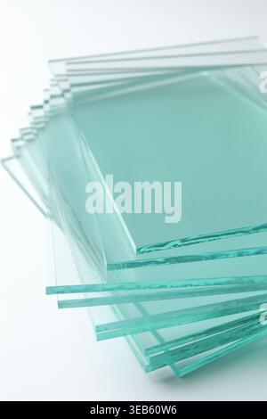 Stack of glass sheets on light background, closeup Stock Photo