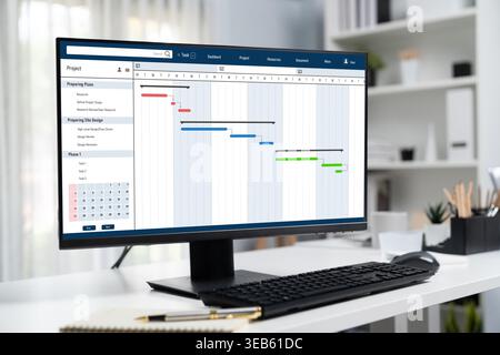 Project planning software for brisk business project management on the computer screen showing timeline chart of the team project Stock Photo