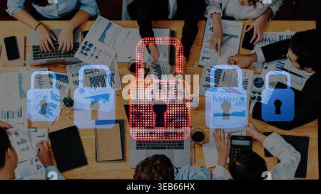 A diverse team collaborates on data analysis in an office setting, focusing on cybersecurity and protecting sensitive information using various Stock Photo
