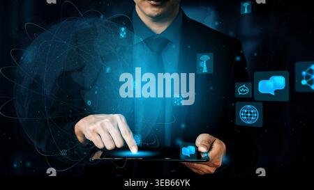 A businessman interacts with a tablet, showcasing digital icons and global networks, symbolizing the intersection of technology and communication in Stock Photo