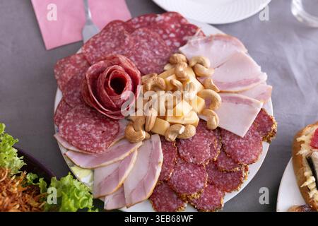 Assorted cold cuts platter with salami, ham, cheese and cashew nuts. Stock Photo