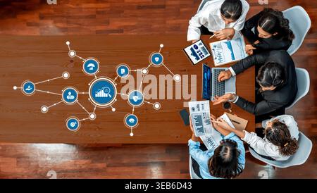A dynamic business meeting scene featuring professionals engaged in data analysis and strategic planning, surrounded by digital icons representing Stock Photo